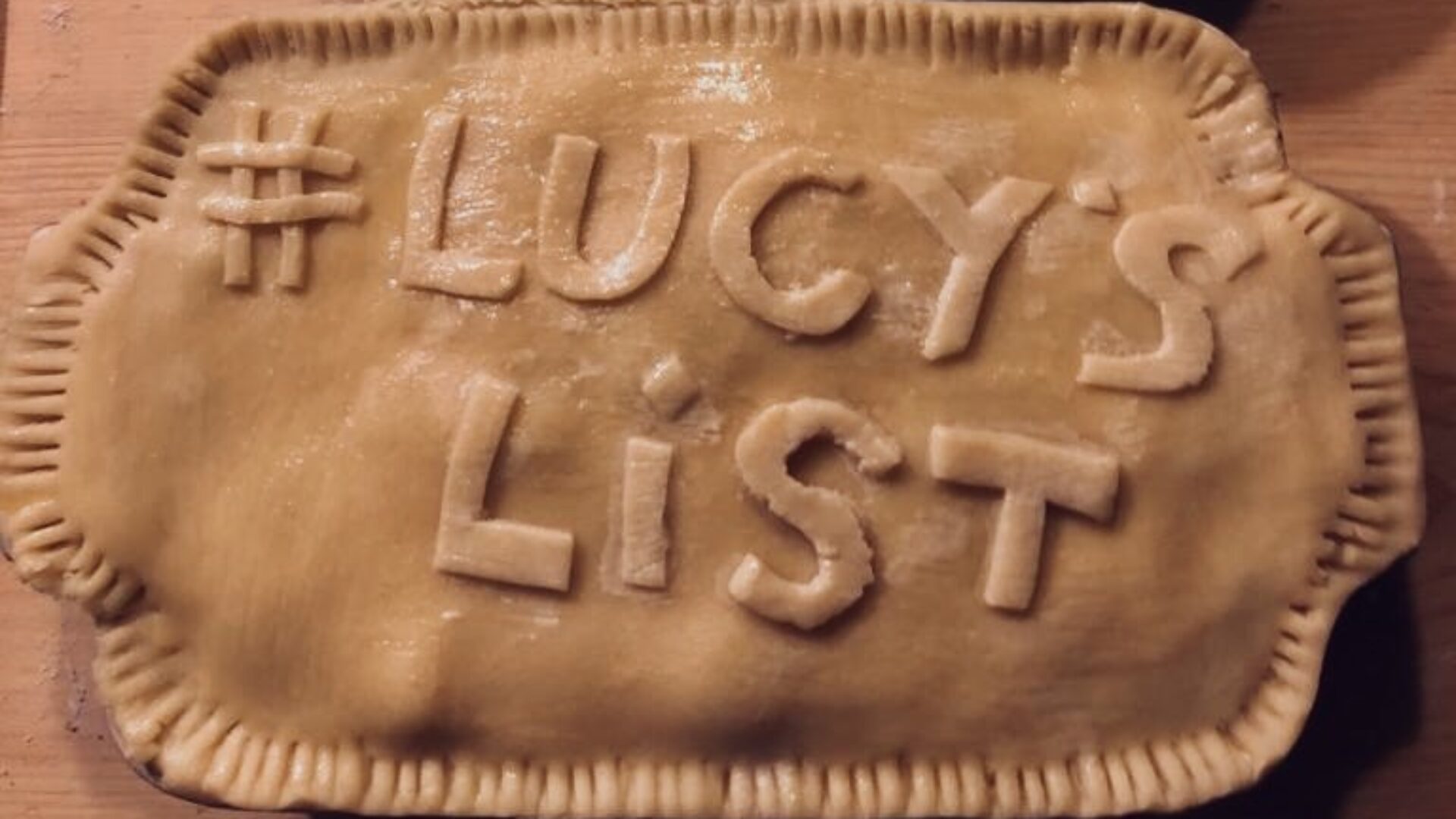 Two pies with "Eat More Pies" and "#Lucy's List" baked into the crusts.