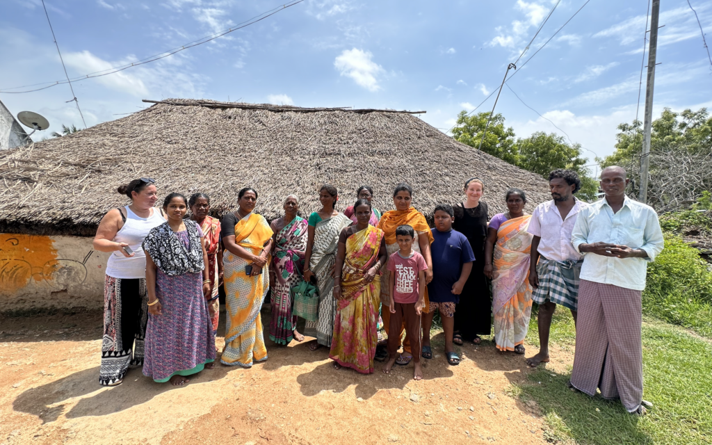 A community of people in Mugaiyur standing together for a group photo.